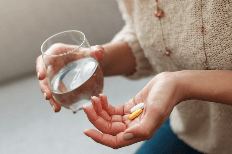 Woman taking menthylated vitamin