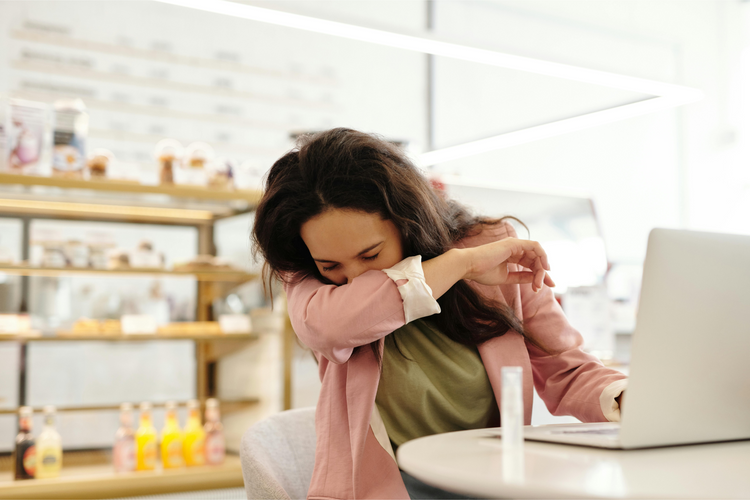 Woman sneexing with allergies