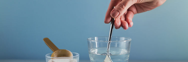Hand stirring a supplement in a cup