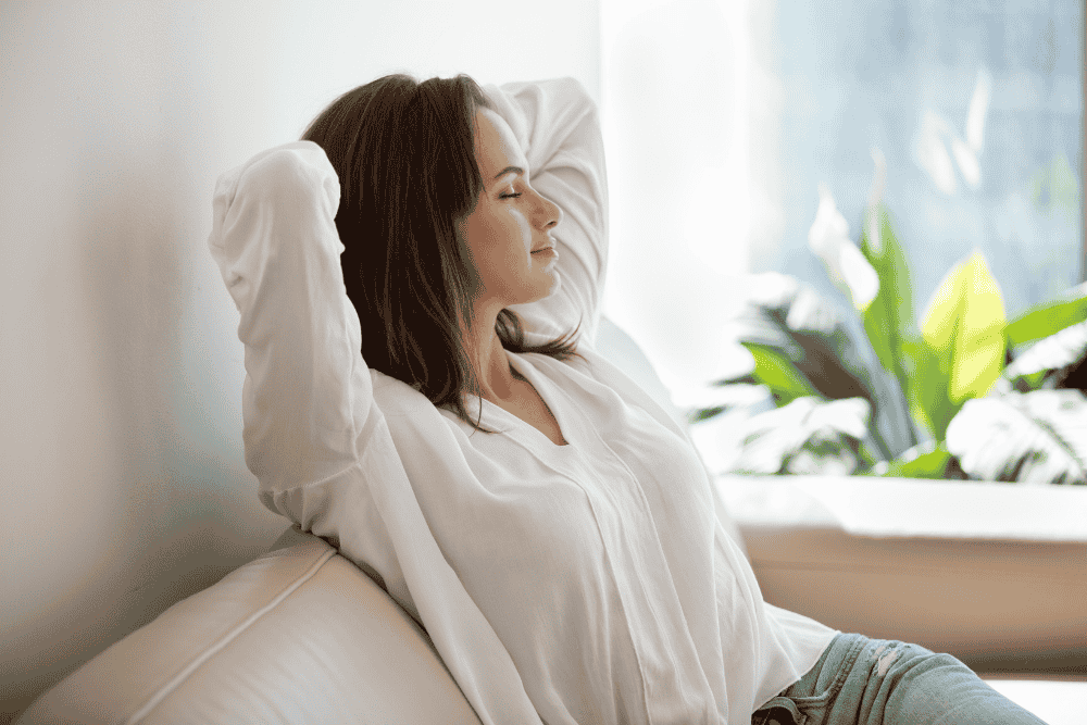 photo of a woman with dark hair relaxing on a couch