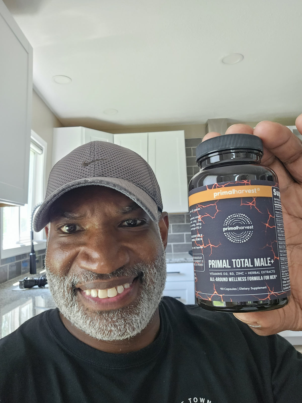 Verified customer Damon holding Primal Total Male+ at home